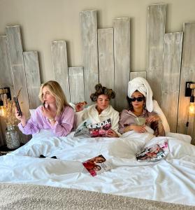 a group of three women laying in bed at Boutique Nouveau Van Ham in Breda