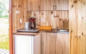 a kitchen with wooden cabinets and a sink at Beautiful Home In Osieki With House Sea View in Osieki