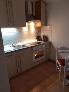 a small kitchen with a stove and a sink at Apartment JANDA - Zadar Croatia in Zadar