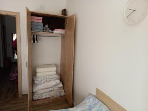 a room with a closet with towels and a clock at Savić Tara in Kaludjerske Bare