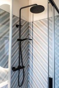 a shower in a bathroom with blue and white stripes at Casa Rural San Andrés de Teixido in Cedeira