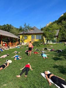 a group of people laying in the grass at Alunis RETREAT in Aluniş