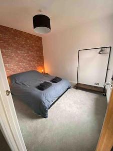 um quarto com uma cama e uma parede de tijolos em 1 bed flat with parking near town centre em Emsworth