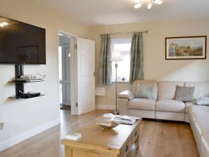 a living room with a couch and a coffee table at Wyedale in Bakewell