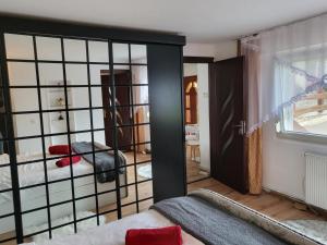 a room with a bed and a large glass door at Vila Sabina ,cu jacuzzi și grătar in terasa exterioara in Satu Mare