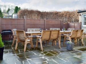 a wooden table and chairs on a patio at Wyedale in Bakewell