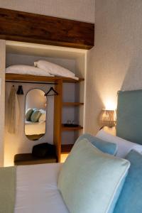 a bedroom with a bunk bed and a mirror at Casa Rural San Andrés de Teixido in Cedeira