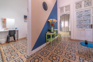 a hallway with a table and a blue wall at Paamonim Central Studios in Jerusalem +29 photos