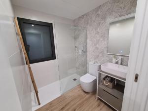 a bathroom with a toilet and a sink and a shower at ESPECTACULAR CASA EN LLAGOSTERA - Costa Brava in Llagostera