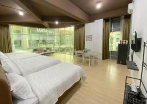 a large bedroom with two beds and a table at CN Homestay C2 Floor 3 at Nagoya Hill Mall in Nagoya