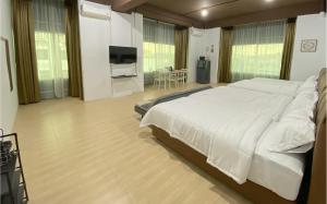 a bedroom with a large white bed and a flat screen tv at CN Homestay C3 Floor 3 at Nagoya Hill Mall in Nagoya