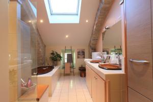 a bathroom with a sink and a bath tub at Le clair de lune in Millau