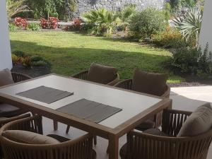 a table and chairs with a table and a yard at Palmmar Jardines NEW 2bedroom ISORA 0,4 Appt 105m2 with garden in Palm-mar