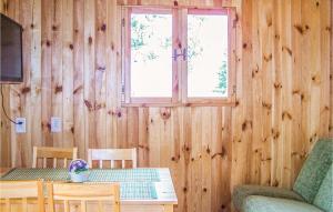 a dining room with a table and a window at Lovely Home In Osieki With Kitchenette in Osieki