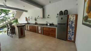a kitchen with a refrigerator and a table in it at villa Mosaic in Tangalle