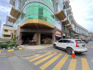 a white car parked in front of a building at CN Homestay A1 Floor 1 at Nagoya Hill Mall in Jodoh +3 photos