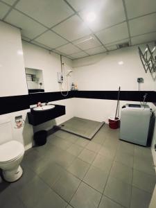 a bathroom with a toilet and a sink at Summer Suites in George Town