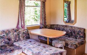 a living room with a couch and a table at Gorgeous Stacaravan In Darlowo in Darłowo