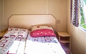 a small bedroom with a bed and a window at Lovely stacaravan In Darlowo With Kitchen in Darłowo