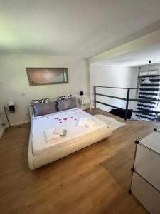Cama blanca grande en habitación con suelo de madera en Madrid Loft duplex en Madrid