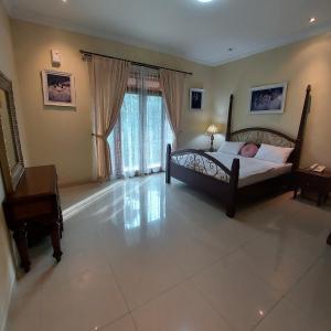 a large bedroom with a bed and a piano at Villa D3 Bukit Cijulang in Bogor +21 photos