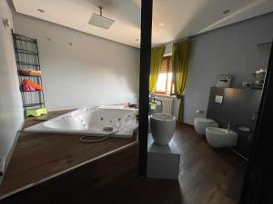 a bathroom with a bath tub and a toilet at Residenza MaryLou in Porto SantʼElpidio +20 photos
