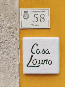 een bord aan de zijkant van een gebouw bij Casa Laura in Corfinio