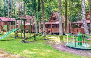 a group of playground equipment in front of a cabin at Gorgeous Apartment In Lukecin With Kitchen in Łukęcin