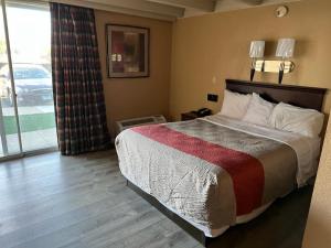 a hotel room with a bed and a large window at Hotel Weston RFD in Rockford