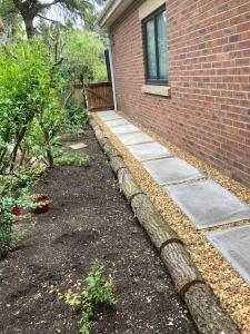 a backyard with a brick building and a garden at Green Little Acre in Little Singleton