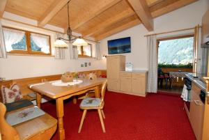 a kitchen with a wooden table in a room at Haus Tasser in Mayrhofen