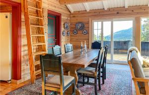 a dining room with a wooden table and chairs at Amazing Home In Fvang With Wifi And 7 Bedrooms in Favang