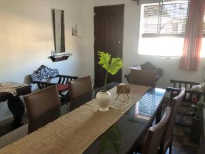 a dining room with a table with a plant in a vase at Las Abuelas in Salto