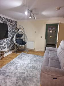 a living room with a couch and a chair at Sunny House in Haydock