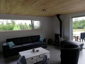 a living room with a couch and a coffee table at L'endroit oublié - Gîtes pour 7 personnes à Spa-Francorchamps in Spa