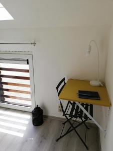 a desk with a chair in a room with a door at L'endroit oublié - Gîtes pour 7 personnes à Spa-Francorchamps in Spa