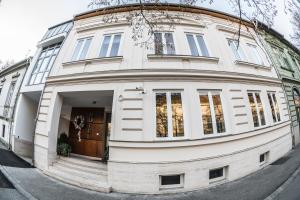 a large white building with a round doorway at Hotel Ankavi in Szeged