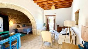 a bedroom with a bed and a table in a room at B&B Monastiriako in Giannoudi