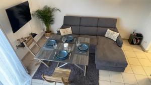 ein Wohnzimmer mit einem Sofa und einem Tisch in der Unterkunft Addis in Salon-de-Provence
