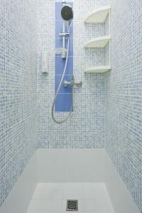 a bathroom with a shower with blue tiles at Итальянские комнаты Пио на канале Грибоедова 35 in Saint Petersburg
