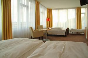 Postel nebo postele na pokoji v ubytování Akcent hotel