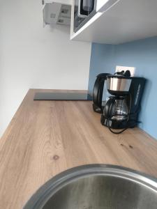a coffee maker on a counter in a kitchen at Super studio rez de jardin avec extérieur in Lozanne