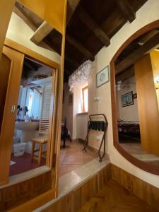 a living room with a mirror and a dining room at Antico Borgo in Fornelli