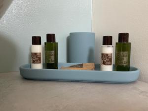 a shelf with four bottles of essential oils on a wall at Casa Mariù in Turi