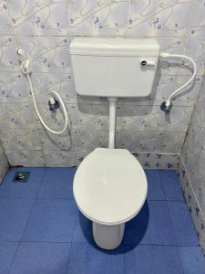bagno con servizi igienici bianchi in camera di Misty Mud House a Idukki