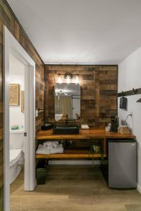 a bathroom with a sink and a mirror at Candlewick Inn and Suites in Eureka Springs