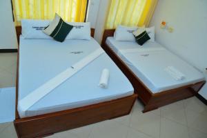 Postel nebo postele na pokoji v ubytování Flamingo Hotel Kinyerezi