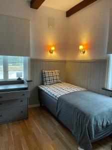a bedroom with a bed and a sink in it at Gästis Vandrarhem i Örkelljunga in Orkelljunga