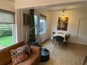 a living room with a couch and a table at Huisje56 in Zoutelande