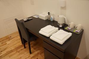 a black desk with two white towels on it at SORAYADO 宙宿 in Tsuru  +89 photos